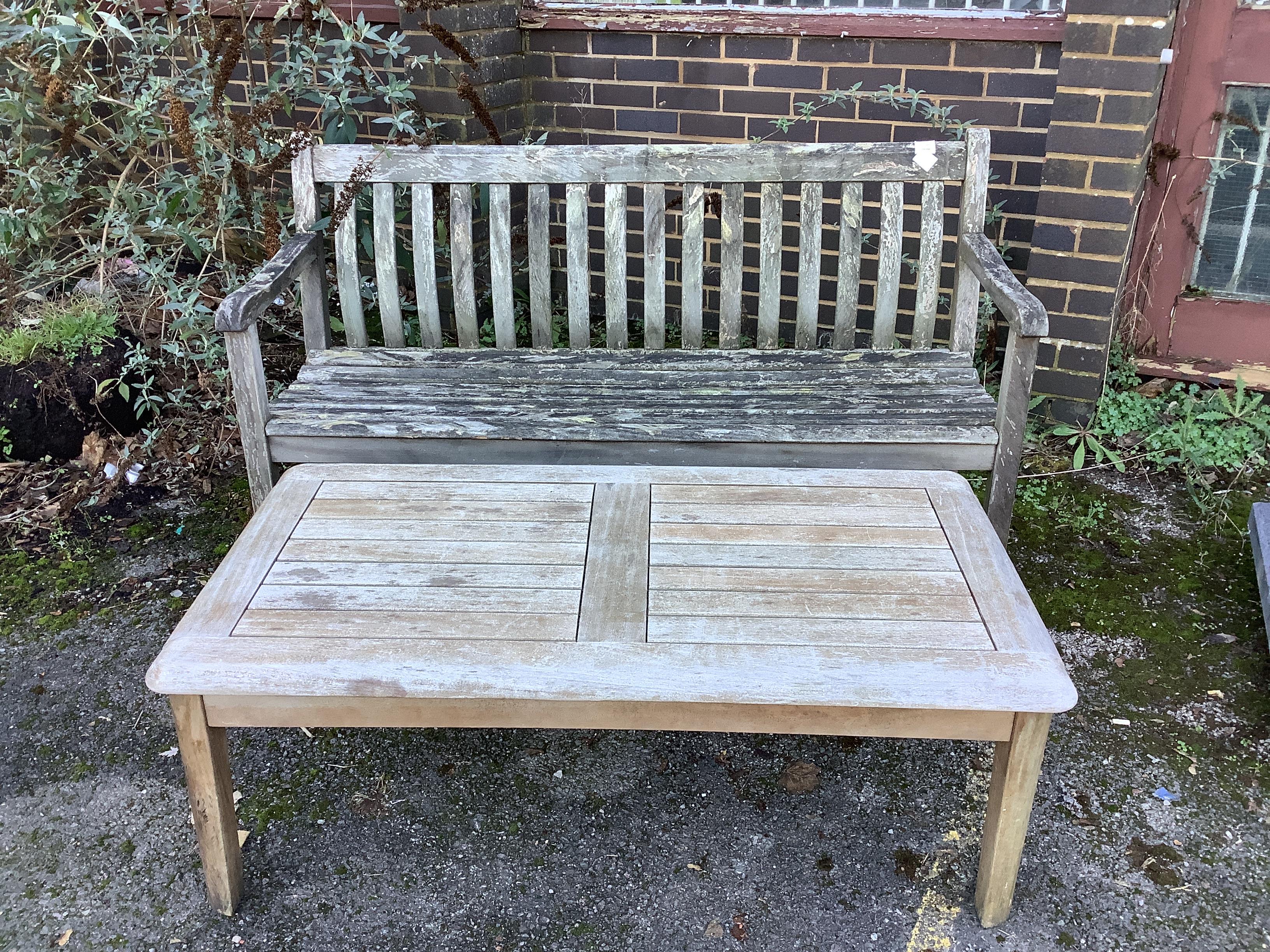 A weathered teak garden bench, length 146cm, depth 53cm, height 88cm and a rectangular teak garden table